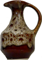 a brown jug with a pattern like owl-wings